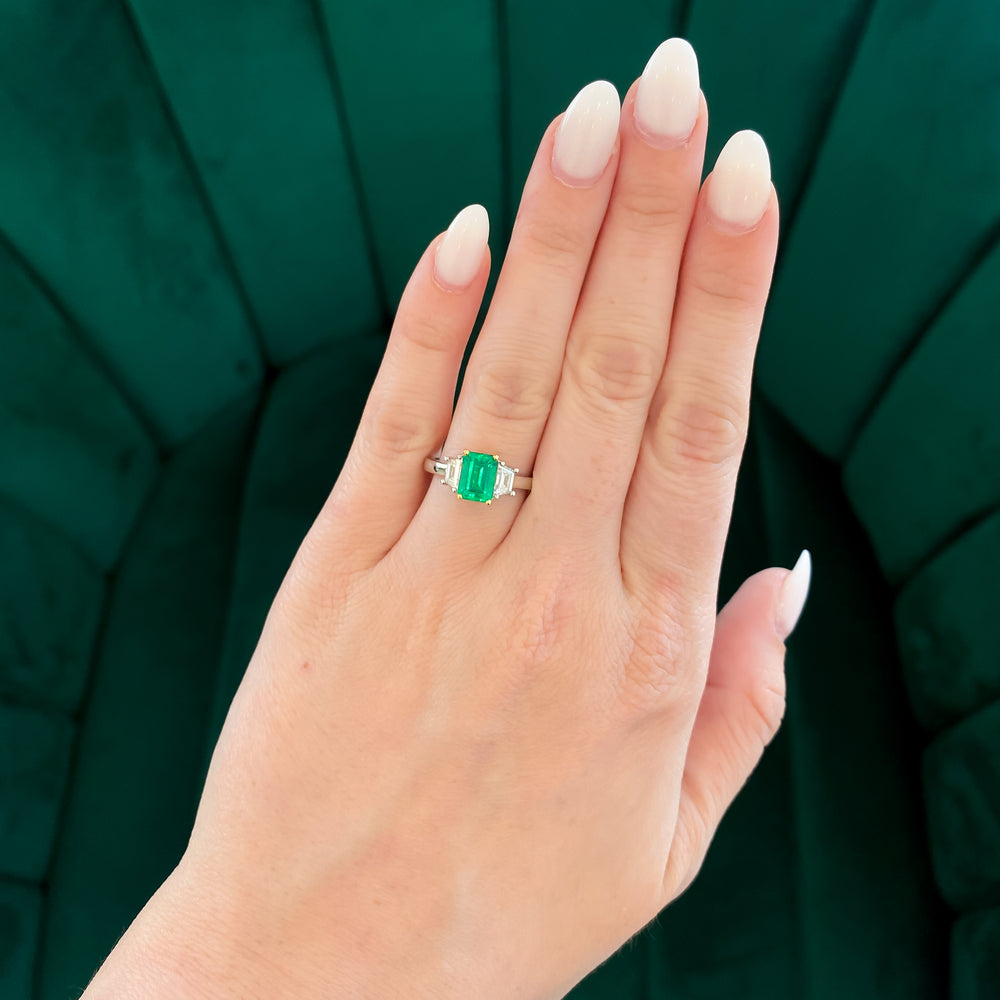 
                  
                    Emerald Three Stone Ring with Trapezoid Diamond Accent Stones
                  
                