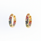 Gold hoop earrings with multicolored gemstones on a white background